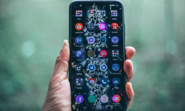 Crop anonymous person using mobile phone with various apps for social network and internet