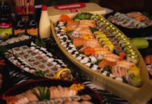 An array of sushi and rolls beautifully arranged on a sushi boat, perfect for a gourmet dinner.