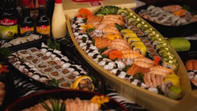An array of sushi and rolls beautifully arranged on a sushi boat, perfect for a gourmet dinner.