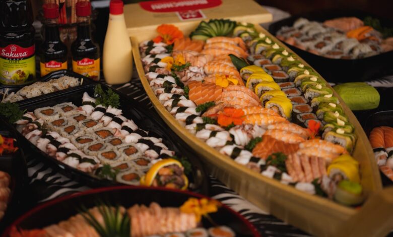 An array of sushi and rolls beautifully arranged on a sushi boat, perfect for a gourmet dinner.