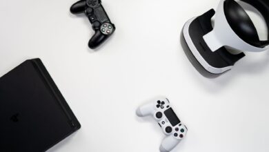 Flat lay of gaming console, controllers, and VR headset on a white background.