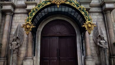 Grand entrance with intricate gold arch and angelic statues adorn the facade.