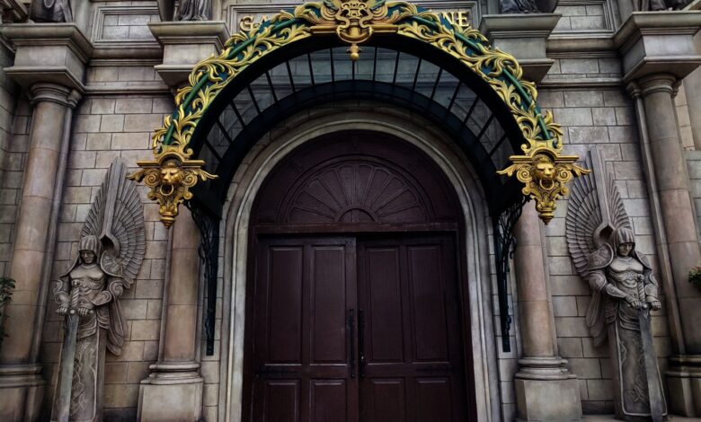 Grand entrance with intricate gold arch and angelic statues adorn the facade.