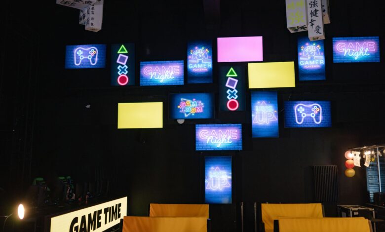 A lively gaming room displaying bright neon signs and screens, creating an immersive atmosphere.