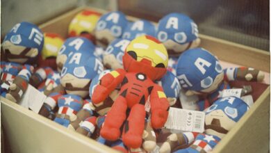 A vibrant collection of superhero dolls displayed in a box, bright and colorful.