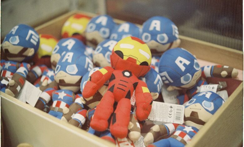 A vibrant collection of superhero dolls displayed in a box, bright and colorful.