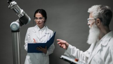 Scientists in lab coats analyze advanced robotics technology, highlighting innovation and teamwork.
