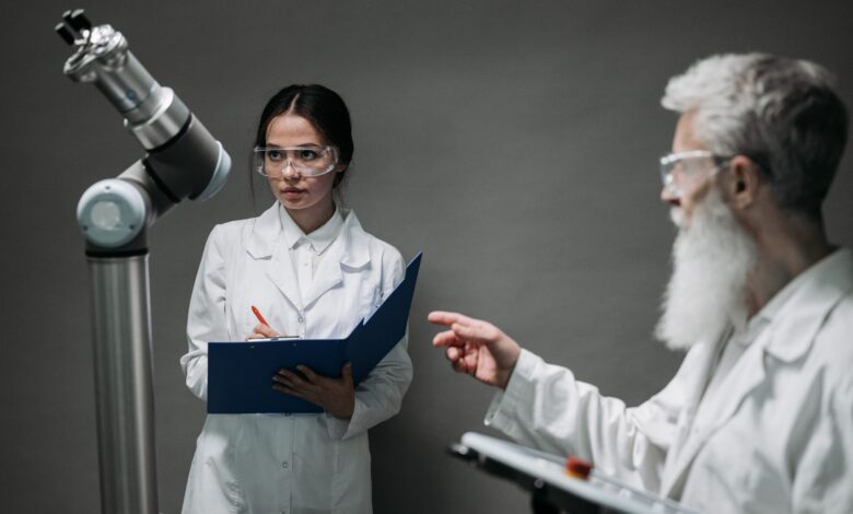 Scientists in lab coats analyze advanced robotics technology, highlighting innovation and teamwork.