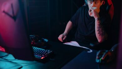 Young man intensely focused on a gaming session at night, highlighting the competitive esports atmosphere.