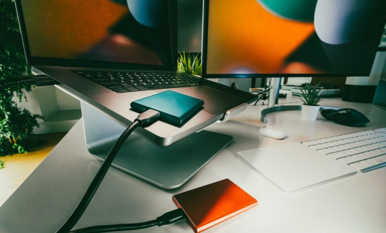Stylish home office setup featuring laptop and external drives for data storage and backup.