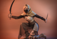 A female warrior in detailed fantasy cosplay, wielding weapons in a studio setting.