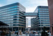Glass and steel office buildings connected by a sky bridge in Kraków, Poland.