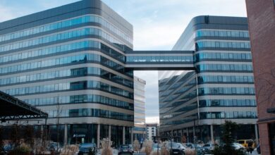 Glass and steel office buildings connected by a sky bridge in Kraków, Poland.