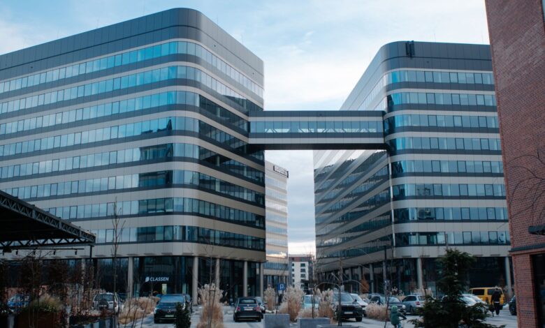 Glass and steel office buildings connected by a sky bridge in Kraków, Poland.