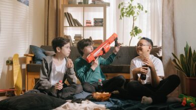 Three kids enjoying a playful and relaxed day inside with snacks and toy guns.