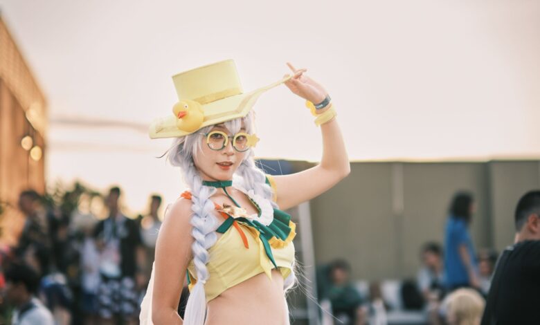 Cosplayer in vivid costume with yellow hat and accessories in an outdoor setting.