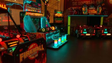 Colorful neon-lit arcade with various game machines including Fireball and Dinosaur Era.