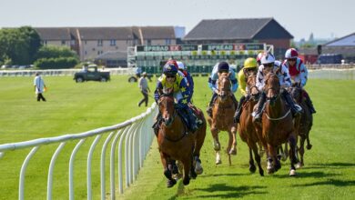 Jockeys compete intensely at the Musselburgh Racecourse in Scotland, showcasing equestrian skill and speed.