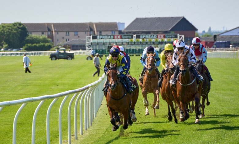 Jockeys compete intensely at the Musselburgh Racecourse in Scotland, showcasing equestrian skill and speed.