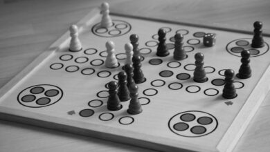 Black and white image of a board game with chess pieces and dice.