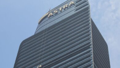 High-rise Astra Tower in Jakarta with window cleaner on a bright day.