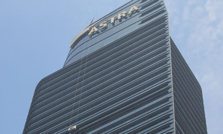 High-rise Astra Tower in Jakarta with window cleaner on a bright day.