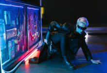 A stylish cyberpunk woman crouching in futuristic neon-lit setting with a gun.