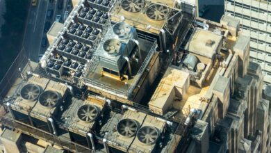 High-angle shot of HVAC units on a city building's rooftop, showcasing industrial infrastructure.