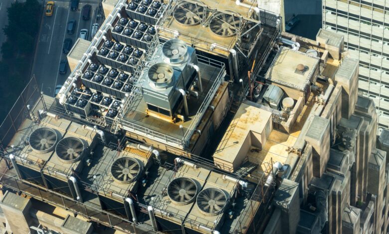 High-angle shot of HVAC units on a city building's rooftop, showcasing industrial infrastructure.
