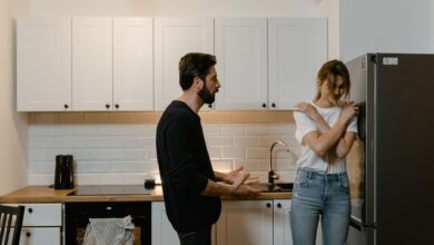 A couple argues in a modern kitchen, illustrating emotional tension and relationship challenges.