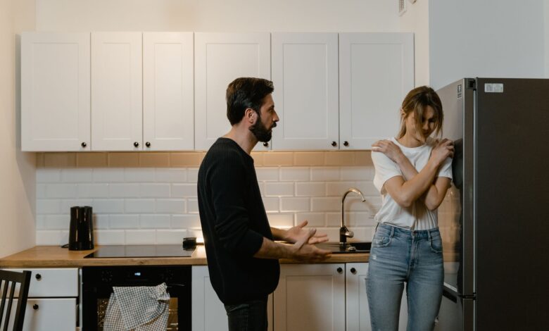 A couple argues in a modern kitchen, illustrating emotional tension and relationship challenges.