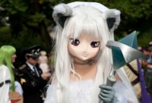 A striking cosplay character with unique costume at an outdoor convention setting.