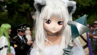 A striking cosplay character with unique costume at an outdoor convention setting.