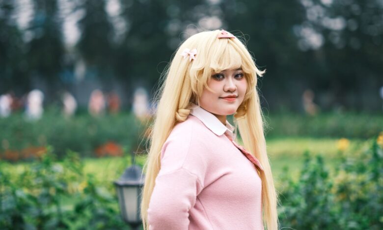 Cosplay enthusiast posing outdoors in a vibrant, lush Vietnamese garden setting.