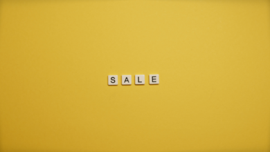Single word 'SALE' spelled with tiles on a bright yellow background, ideal for advertising.