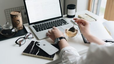 A cozy home office scene with a laptop, tea, and workspace essentials.