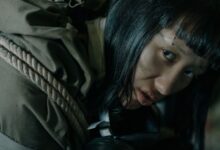 A woman with eyebrow piercing in urban survival gear, conveying a dystopian feel.