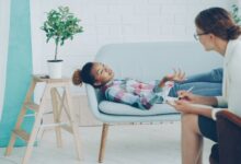 Cozy therapy office with client and therapist during a session.