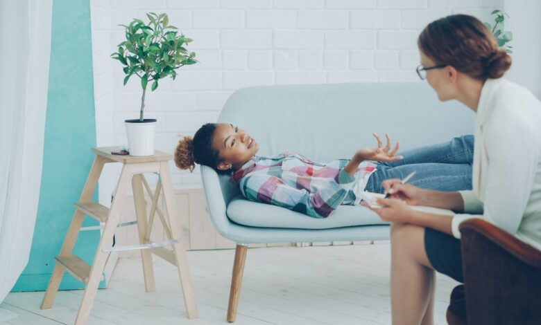 Cozy therapy office with client and therapist during a session.