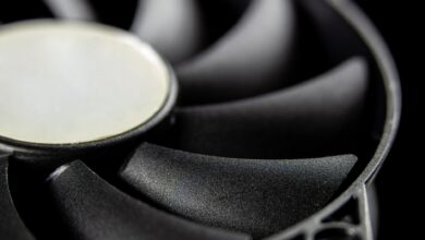 Macro close-up of a modern computer cooling fan blade, showcasing intricate details.