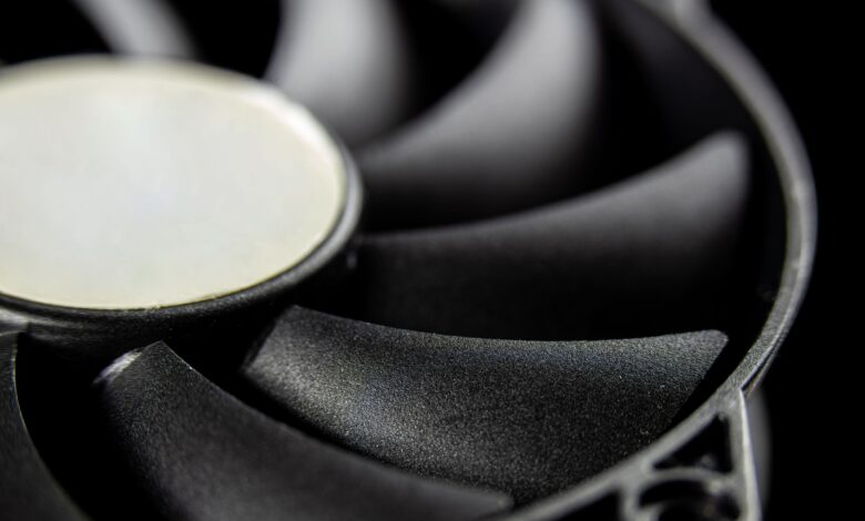 Macro close-up of a modern computer cooling fan blade, showcasing intricate details.
