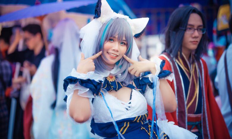 A cheerful cosplayer in a colorful anime costume poses at an outdoor event.