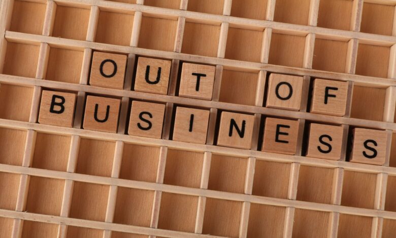 Wooden blocks spelling out 'Out Of Business' symbolize closure or economic downturn.