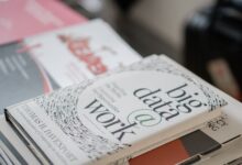 Close-up of books on data analytics and business strategies on a desk.