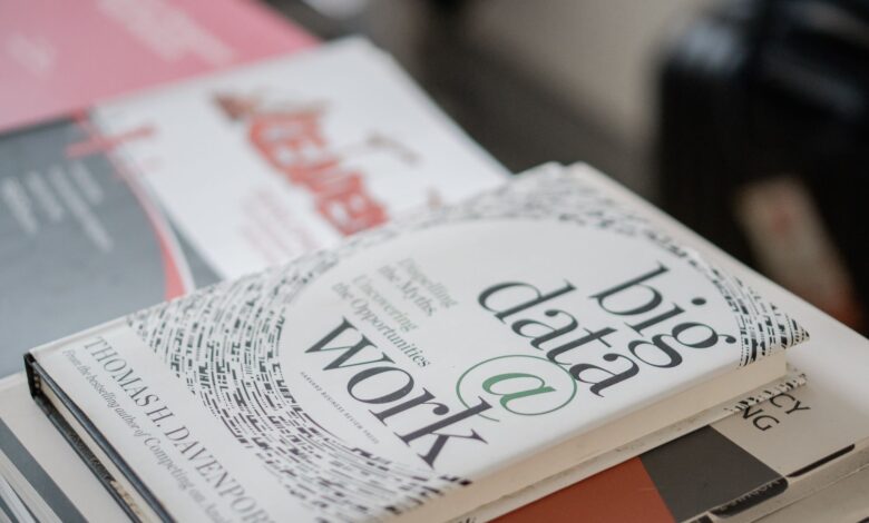 Close-up of books on data analytics and business strategies on a desk.