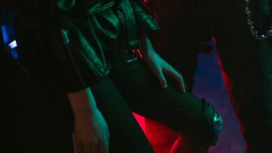 Stylish fashion shot with neon lighting and leather attire, highlighting cyberpunk aesthetics.