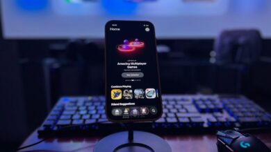 A stylish gaming setup featuring a smartphone on a stand with a vibrant display, keyboard, and mouse.