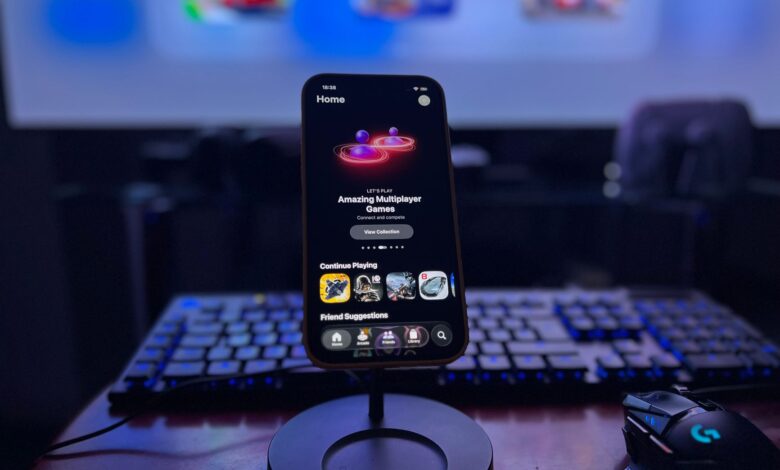 A stylish gaming setup featuring a smartphone on a stand with a vibrant display, keyboard, and mouse.