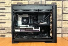 Detailed view of a custom-built gaming PC with visible components like graphics card and cooling system.