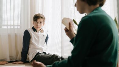 Two kids engaging in a card game indoors, enjoying leisure time and strategic gameplay.